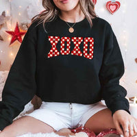 May include a crewneck sweatshirt with an XOXO checkered design featuring a soft, furry-style printed texture.