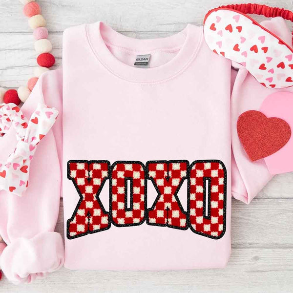 May include a crewneck sweatshirt with an XOXO checkered design featuring a soft, furry-style printed texture.