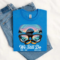 Blue Alaska adventure anniversary t-shirt with sunglasses, cruise ship, mountains, and whales graphic