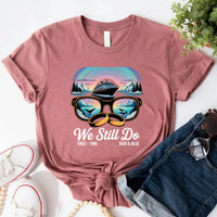 May include a personalized couple’s t-shirt with the phrase “Alaska Adventure We Still Do,” featuring travel-themed graphics, perfect for anniversaries and outdoor-loving partners.