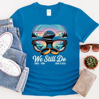 Blue personalized anniversary T-shirt with Alaska cruise print, sunglasses, rings, and custom names.