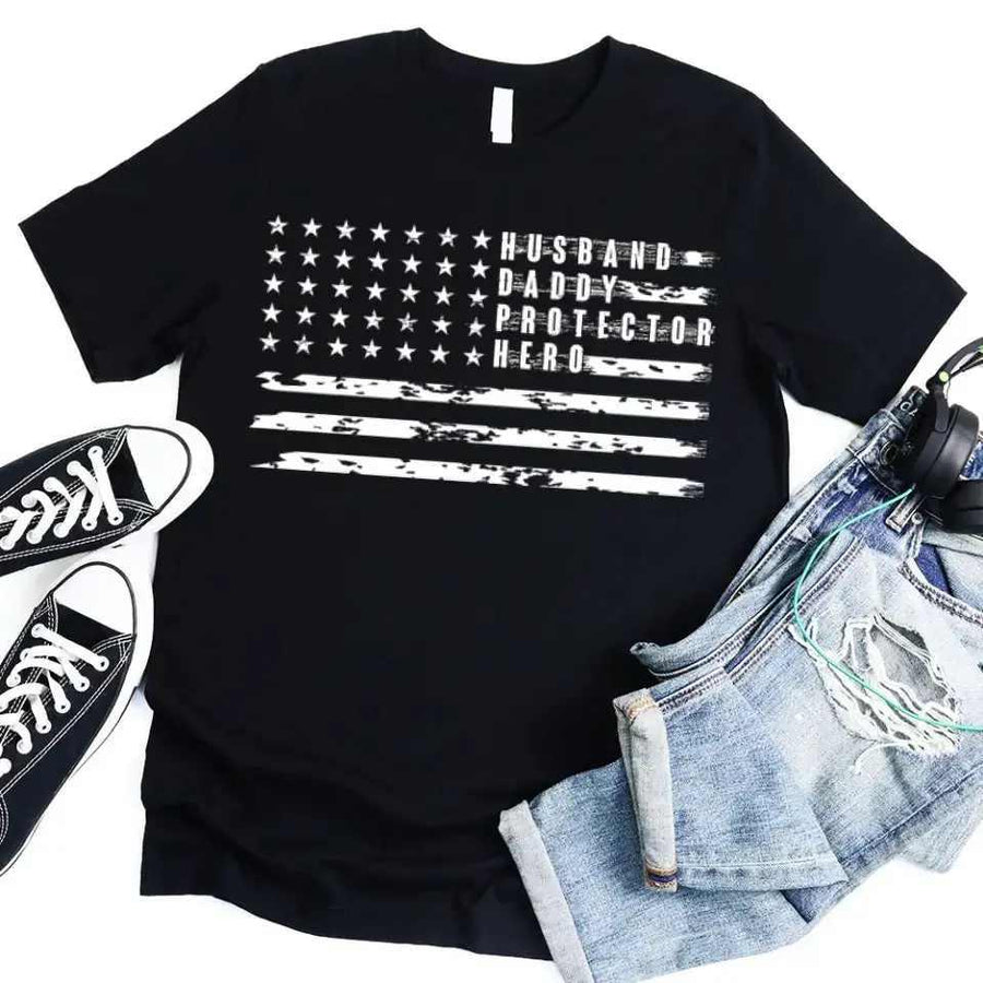 Black Father's Day t-shirt with American flag and 'Husband Daddy Protector Hero' text.