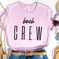 Lavender t-shirt with 'bach CREW' text, worn with denim jeans and a brown belt.