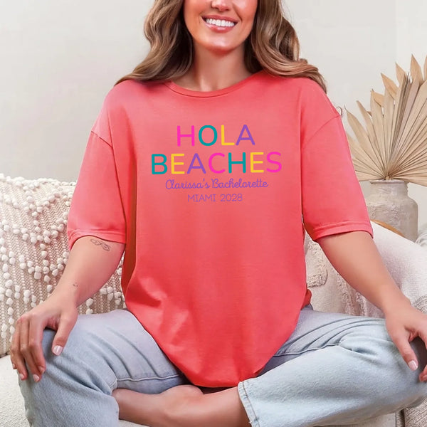 May include Coral Silk colorful “Bride Tribe” beach bachelorette T-shirts worn by a group of women, vibrant summer tones, seaside backdrop, fun party vibe, coordinated bridal crew outfits celebrating together!