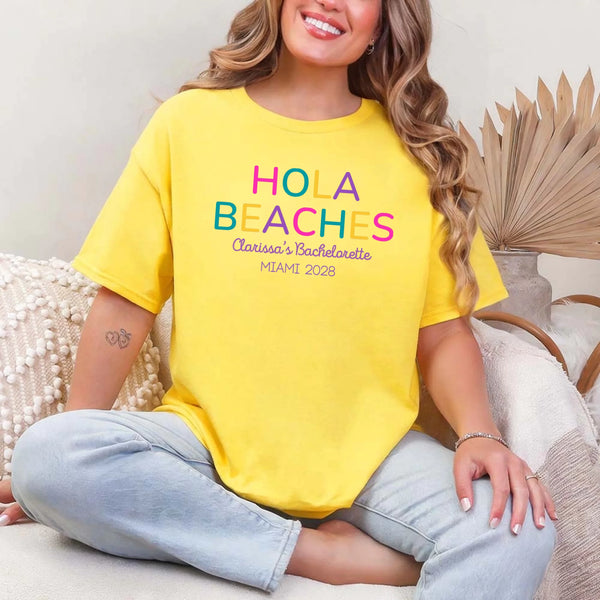 May include Daisy colorful “Bride Tribe” beach bachelorette T-shirts worn by a group of women, vibrant summer tones, seaside backdrop, fun party vibe, coordinated bridal crew outfits celebrating together!