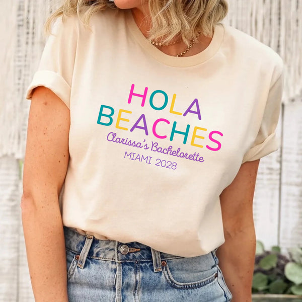 May include Cream colorful “Bride Tribe” beach bachelorette T-shirts worn by a group of women, vibrant summer tones, seaside backdrop, fun party vibe, coordinated bridal crew outfits celebrating together!