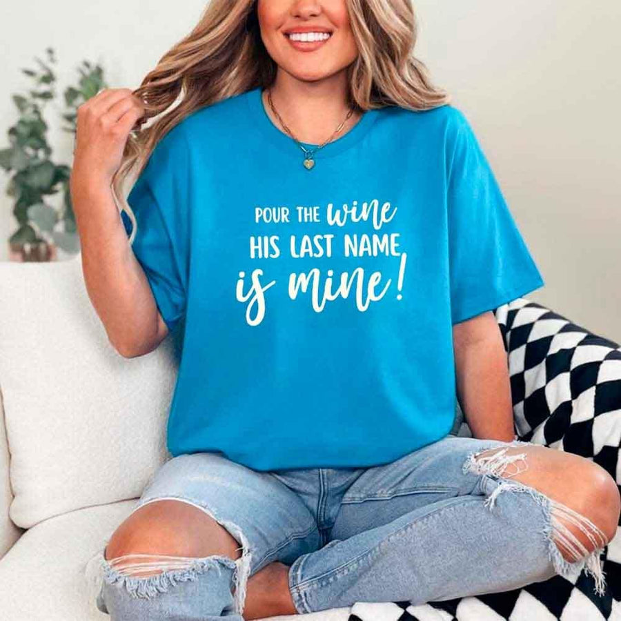 May include Sapphire Bachelorette Party Shirt with "Pour The Wine His Last Name Is Mine" T-Shirt design, perfect for bridal celebrations, fun nights, and making a statement!