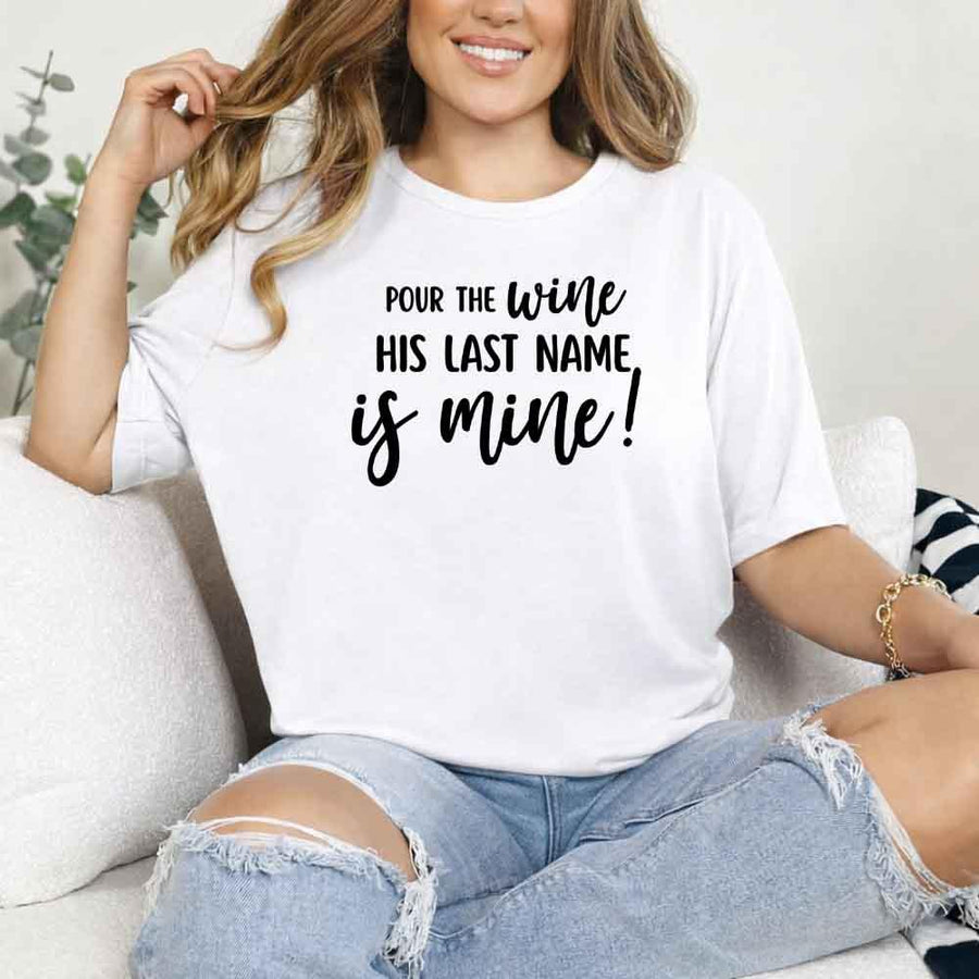 May include White Bachelorette Party Shirt with "Pour The Wine His Last Name Is Mine" T-Shirt design, perfect for bridal celebrations, fun nights, and making a statement!