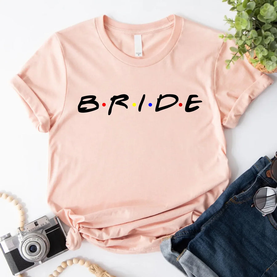 Peach graphic T-shirt with bold text reading “Bride,”