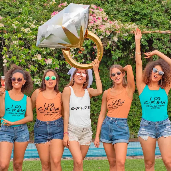 Group of women in matching 'I Do Crew' shirts celebrating outdoors.