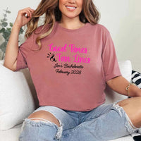 May include Mauve a group of women wearing matching personalized bridal party T-shirts with “Bachelorette Party Time” text, celebrating together with smiles, drinks, and festive party decorations!
