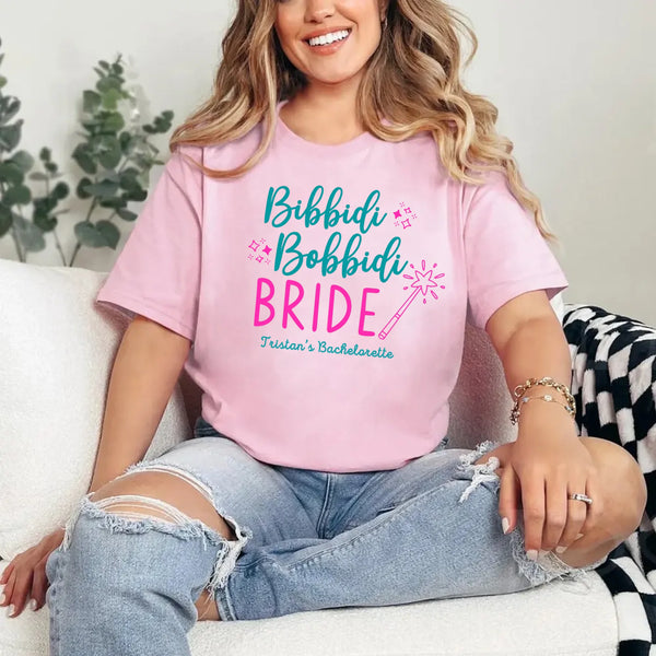 May include Pink a personalized Bibbidi Bobbidi Bride T-shirt with fairytale bridal lettering for a bachelorette party or wedding celebration.