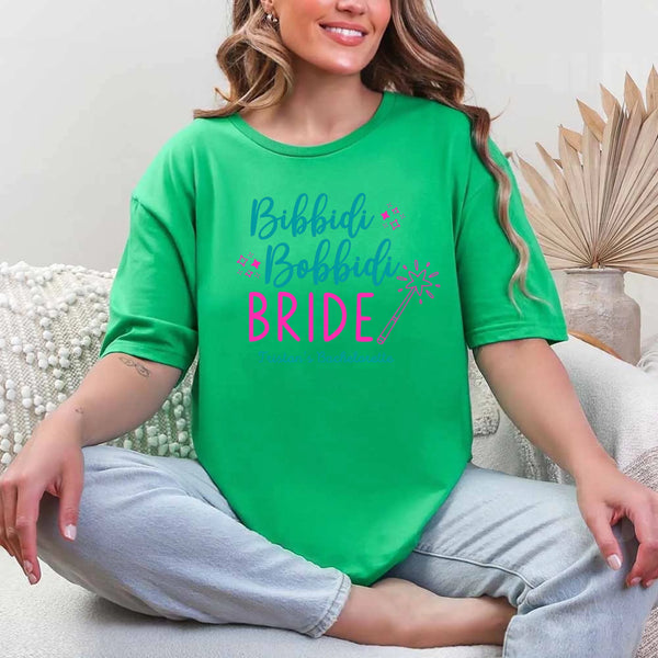 May include Green a personalized Bibbidi Bobbidi Bride T-shirt with fairytale bridal lettering for a bachelorette party or wedding celebration.
