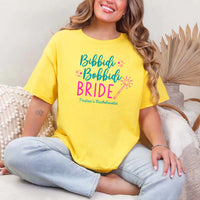 May include Daisy a personalized Bibbidi Bobbidi Bride T-shirt with fairytale bridal lettering for a bachelorette party or wedding celebration.