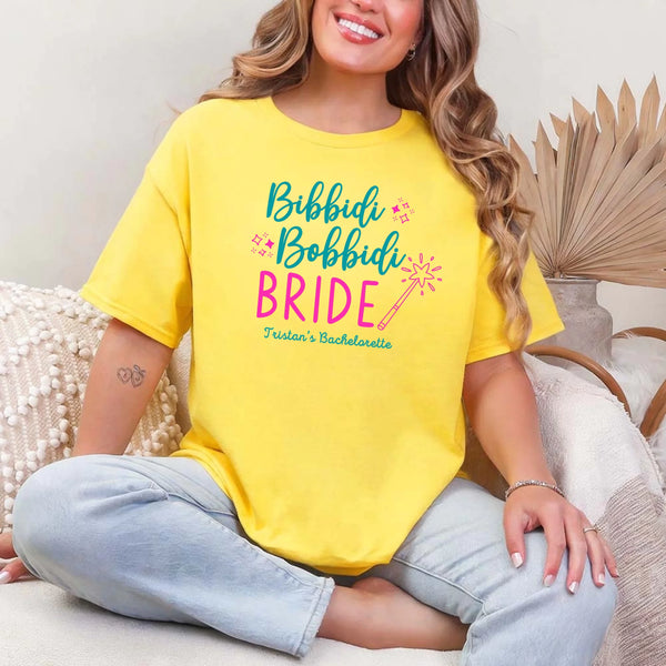 May include Daisy a personalized Bibbidi Bobbidi Bride T-shirt with fairytale bridal lettering for a bachelorette party or wedding celebration.