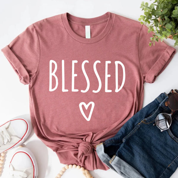 May include parent and child wearing a mauve Blessed Parent and Mini matching t-shirts.
