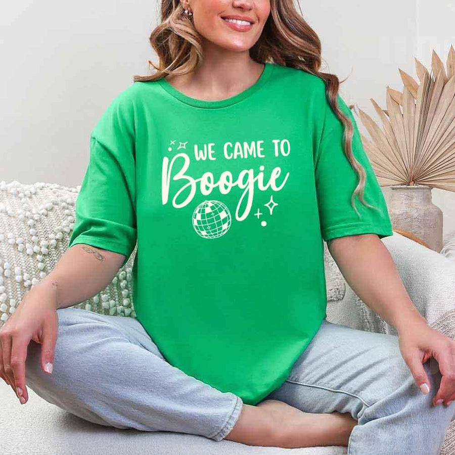 May include an Irish Green retro-style graphic tee with bold disco lettering reading “Boogie With Me, I’m The Bride To Be,” featuring playful fonts and festive design elements!