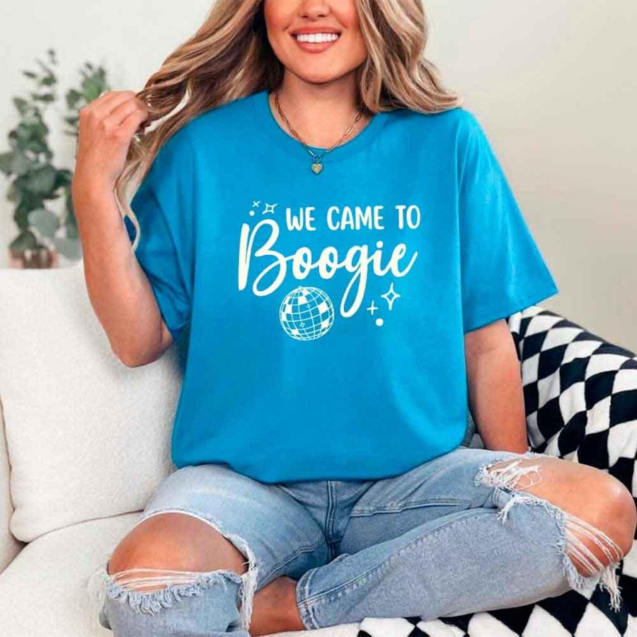 May include a Sapphire retro-style graphic tee with bold disco lettering reading “Boogie With Me, I’m The Bride To Be,” featuring playful fonts and festive design elements!