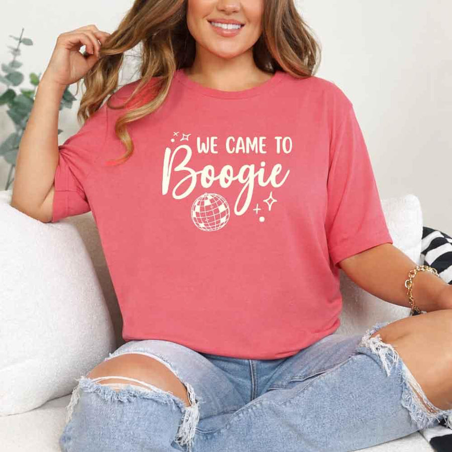May include a Coral Silk retro-style graphic tee with bold disco lettering reading “Boogie With Me, I’m The Bride To Be,” featuring playful fonts and festive design elements!