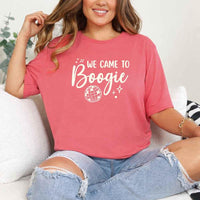 May include a Coral Silk retro-style graphic tee with bold disco lettering reading “Boogie With Me, I’m The Bride To Be,” featuring playful fonts and festive design elements!