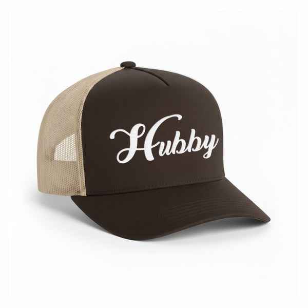 May include an embroidered trucker hat featuring the word “Hubby” stitched in clean, classic lettering on the front panel, designed with a structured crown and breathable mesh back for a timeless wedding or anniversary accessory.