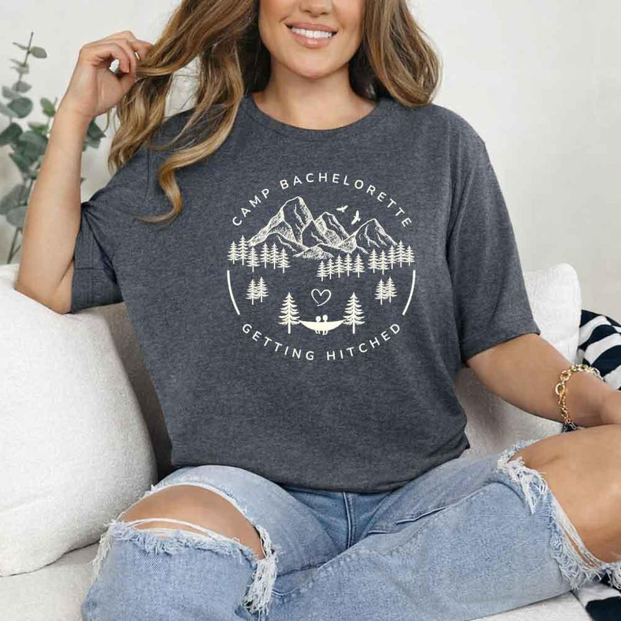 May include Dark Heather camp themed Bachelorette t shirts with fun outdoor slogans cozy vibes bridal squad outfits perfect for camping trip celebrations and girls getaway!