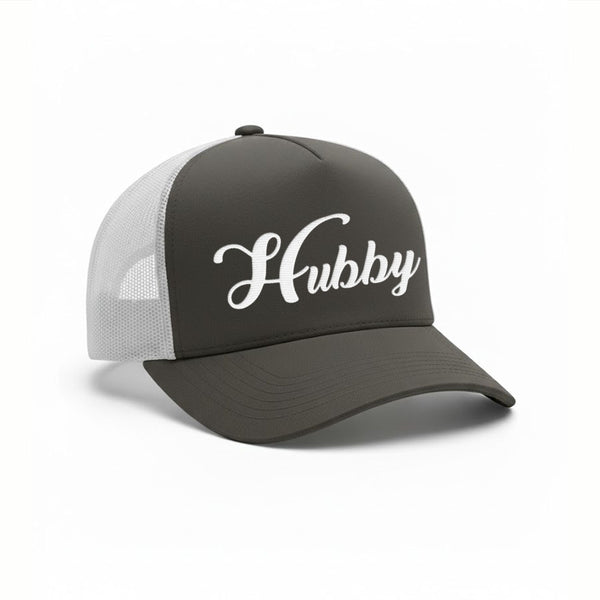 May include an embroidered trucker hat featuring the word “Hubby” stitched in clean, classic lettering on the front panel, designed with a structured crown and breathable mesh back for a timeless wedding or anniversary accessory.