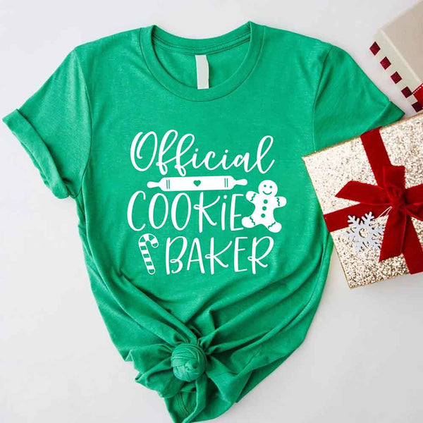 May include a Christmas-themed t-shirt reading “Official Cookie Baker and Tester,” featuring festive colors and cookie graphics, ideal for holiday bakers.