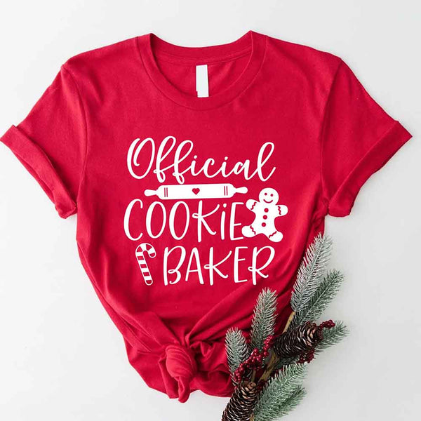 May include a Christmas-themed t-shirt reading “Official Cookie Baker and Tester,” featuring festive colors and cookie graphics, ideal for holiday bakers.