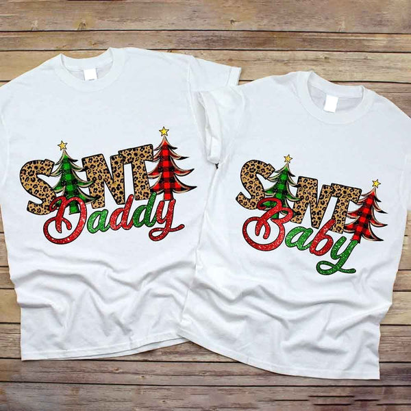 May include a Christmas Santa Baby tee with a festive graphic printed on the front, displayed on a plain background.