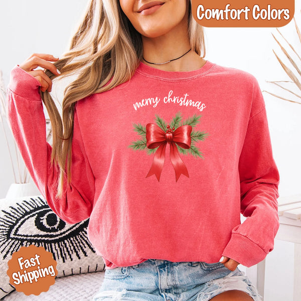 May include a Comfort Colors T-shirt featuring a Christmas bow graphic in coquette aesthetic style with soft vintage tones.