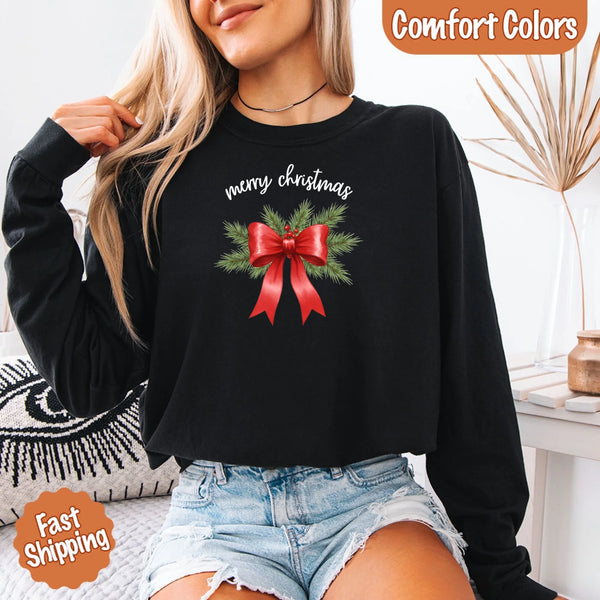 May include a Comfort Colors T-shirt featuring a Christmas bow graphic in coquette aesthetic style with soft vintage tones.