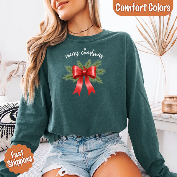 May include a Comfort Colors T-shirt featuring a Christmas bow graphic in coquette aesthetic style with soft vintage tones.