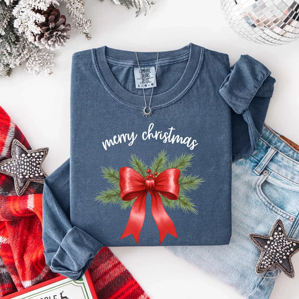 May include a Comfort Colors T-shirt featuring a Christmas bow graphic in coquette aesthetic style with soft vintage tones.