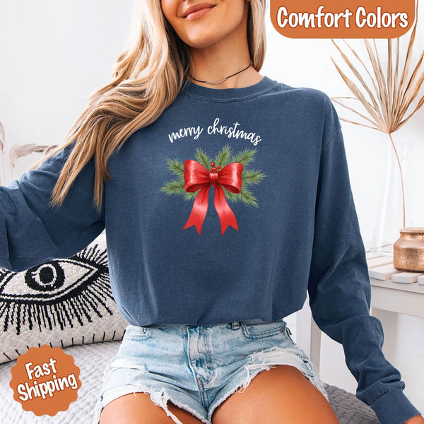 May include a Comfort Colors T-shirt featuring a Christmas bow graphic in coquette aesthetic style with soft vintage tones.