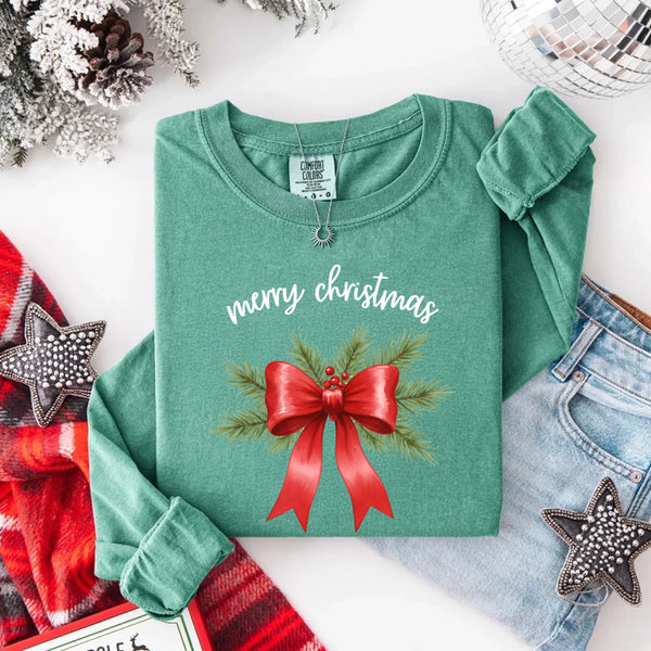 May include a Comfort Colors T-shirt featuring a Christmas bow graphic in coquette aesthetic style with soft vintage tones.