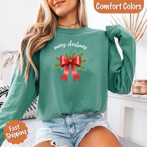 May include a Comfort Colors T-shirt featuring a Christmas bow graphic in coquette aesthetic style with soft vintage tones.
