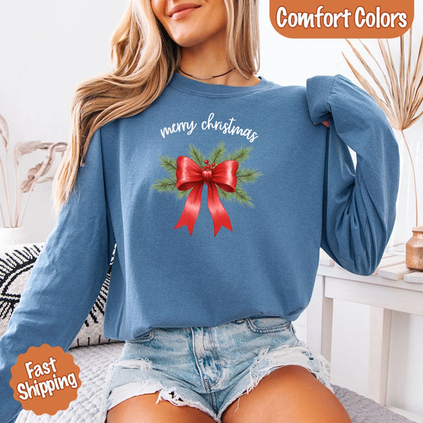 May include a Comfort Colors T-shirt featuring a Christmas bow graphic in coquette aesthetic style with soft vintage tones.