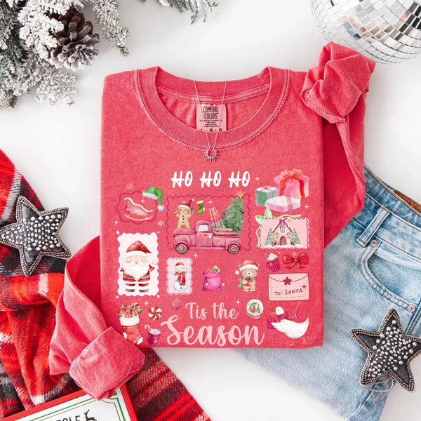 May include a Comfort Colors long sleeve unisex Christmas shirt with “Ho Ho Ho Tis The Season” text design in festive holiday style.