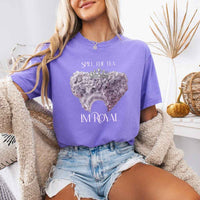 May include a person wearing a Violet Comfort Colors Spill the Tea I’m Royal T-Shirt featuring regency gossip inspired graphic and relaxed fit.