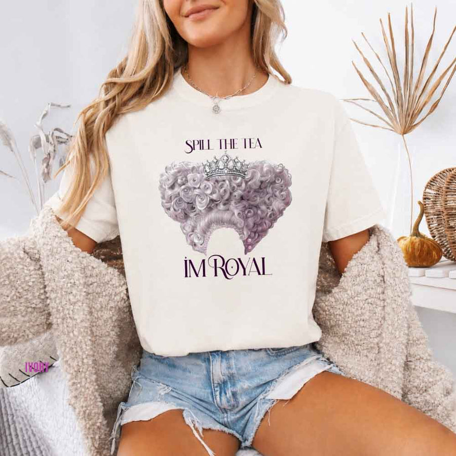 May include a person wearing a Ivory Comfort Colors Spill the Tea I’m Royal T-Shirt featuring regency gossip inspired graphic and relaxed fit.