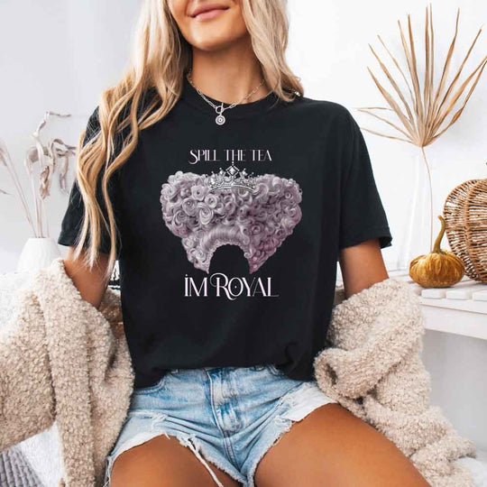 May include a person wearing a Black Comfort Colors Spill the Tea I’m Royal T-Shirt featuring regency gossip inspired graphic and relaxed fit.