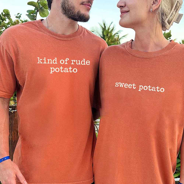May include a pair of matching fall-themed couple t-shirts from Comfort Colors featuring playful “Sweet Potato” and “Rude Potato” designs. The shirts are styled with humorous graphics or text in warm autumn tones, perfect for couples celebrating the season with a lighthearted touch.