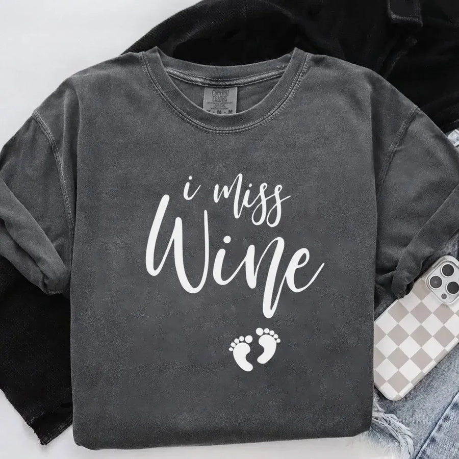 Charcoal gray unisex t-shirt with 'I miss wine' text and small baby footprints graphic.