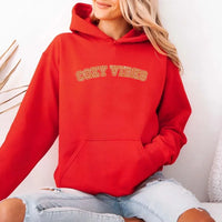 May include a unisex fall hoodie with “Cozy Vibes” text, featuring a soft fleece texture and autumn-inspired colors.