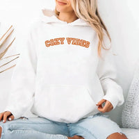 May include a unisex fall hoodie with “Cozy Vibes” text, featuring a soft fleece texture and autumn-inspired colors.
