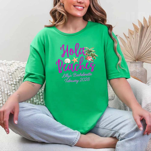 May include Green bridesmaids wearing custom matching beach bachelorette T-shirts, relaxed seaside setting with sand and ocean backdrop, coordinated outfits, smiling and celebrating together outdoors!