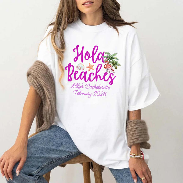 May include White bridesmaids wearing custom matching beach bachelorette T-shirts, relaxed seaside setting with sand and ocean backdrop, coordinated outfits, smiling and celebrating together outdoors!