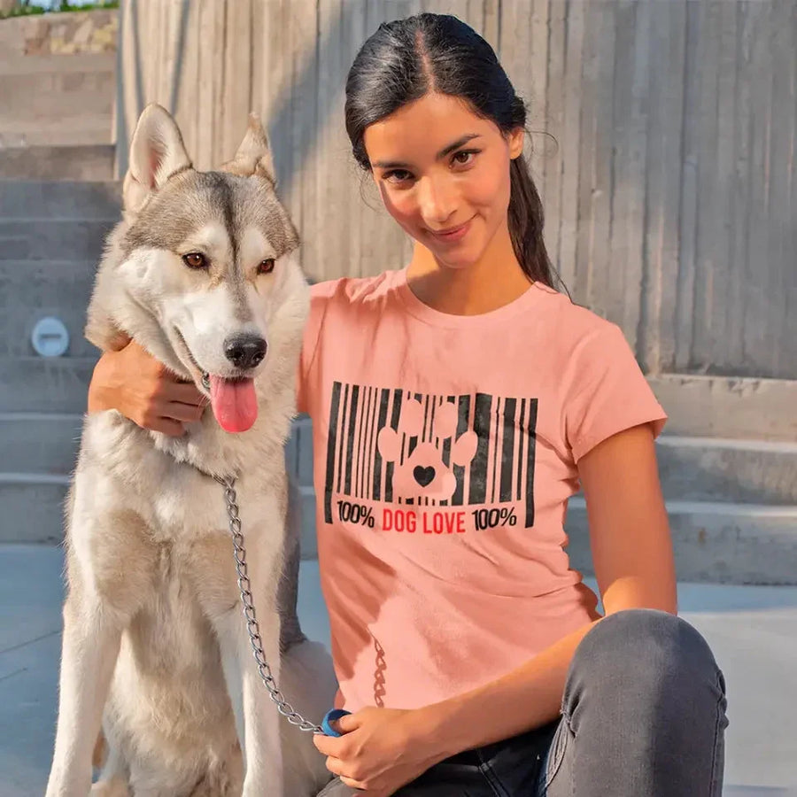 Woman wearing a pink dog lover barcode tee, sitting with a husky dog outdoors.