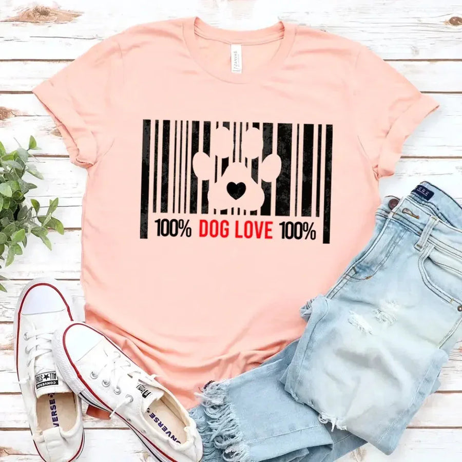 Peach t-shirt with '100% Dog Love' barcode and paw print design, styled with jeans and sneakers.